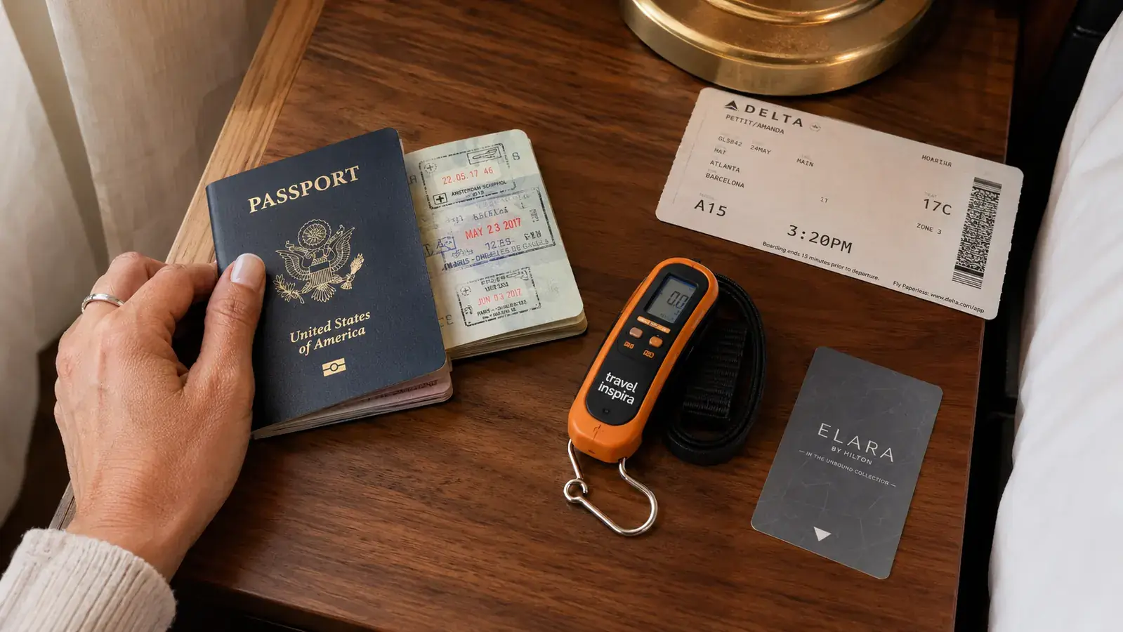 travel inspira luggage scale next to a worn passport and boarding pass, showing the compact size